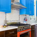 bold dual range and hood with ceramic tile backsplash