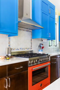 bold dual range and hood with ceramic tile backsplash