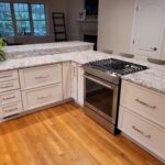 two-tier peninsula with seating and range oven